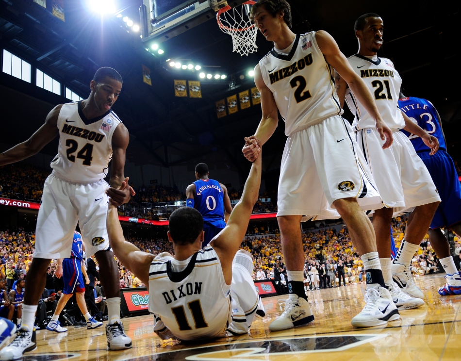 MU basketball players Kim English and Ricky Kreklow help Michael Dixon to his feet during Saturday's game against KU on March 5, 2011. The Jayhawks beat the Tigers 70-66.